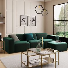 a modern living room with teal couches and coffee table in front of large windows