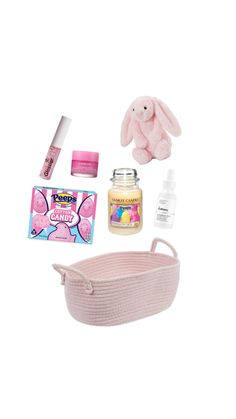 the contents of a pink basket and its contents are arranged on a white background, including a stuffed bunny