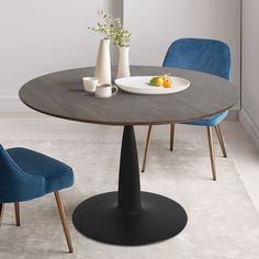 a round table with two blue chairs around it