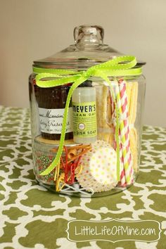 a jar filled with lots of different types of items on top of a green and white table