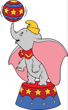 an elephant with a cape on top of a circus ring holding a ball in it's trunk