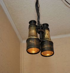 two binoculars are hanging from the ceiling