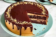 a chocolate cake on a plate with one slice cut out and the other half eaten