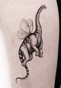 a black and white image of a dinosaur with a bee on its back leg tattoo