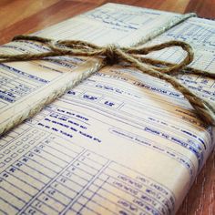 an old book wrapped in twine and tied with rope on top of a wooden floor