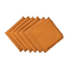 six orange napkins with fringe edges on white background