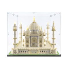 a model of a building in a glass case on a white surface with lights around it