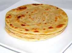 three flat breads on a white plate