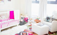 a baby's room is decorated in pink and white, including a crib