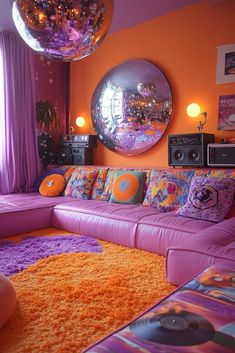 a living room filled with purple couches and disco ball mirrors on the wall above them