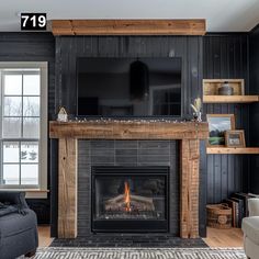 a living room with a fire place and tv on the fireplace mantel in front of it