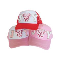 two pink and white hats with the word yy on them, one has a red brimmed visor