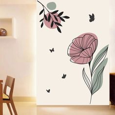 a wall with flowers and butterflies on it in a room next to a wooden table