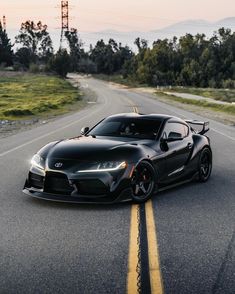 a black sports car driving down the road