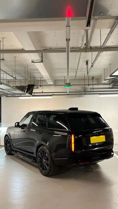 an suv parked in a parking garage with no one around or looking at the camera