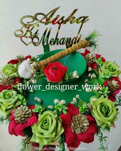 there is a green hat with red flowers on it and the words above it reads, flower designer work