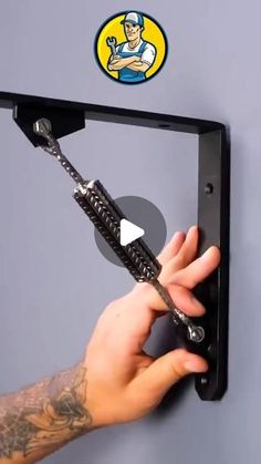 a hand is pulling the handle on a wall mounted device