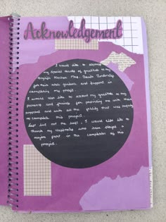 a purple notebook with writing on it