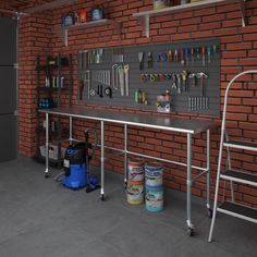 a workbench with tools hanging on the wall