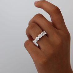 a woman's hand with a diamond ring on her left hand and three diamonds in the middle