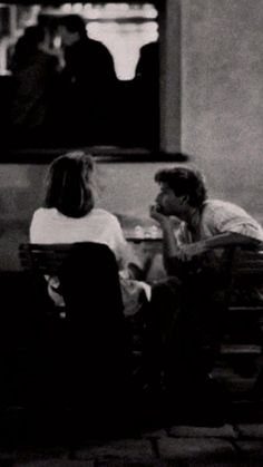 black and white photograph of two people sitting at a table