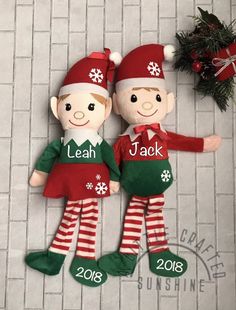 two christmas dolls sitting next to each other on a tile floor with the words leap and jack