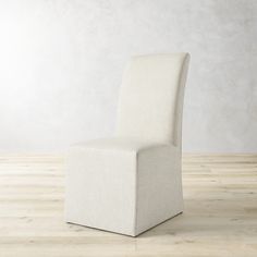 a white chair sitting on top of a wooden floor