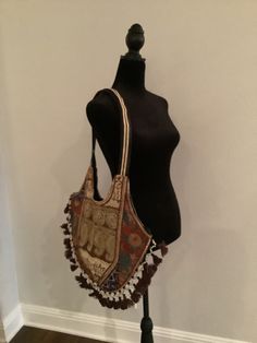 "Boho shoulder bag. Cotton bag with shear material on outside that is embroidered. Colors are brown, gold, and touches of deep blue and peach.  The opposite side is similar but also has some touches of red and green embroidery.  Unique and elegant piece. 15\" height, 18\" length" Brown Embroidered Hobo Shoulder Bag, Multicolor Embroidered Hobo Shoulder Bag For Travel, Embroidered Brown Hobo Shoulder Bag, Travel-ready Multicolor Embroidered Hobo Shoulder Bag, Multicolor Embroidered Shoulder Hobo Bag For Travel, Travel Hobo Bag With Multicolor Embroidery, Vintage Rectangular Bags With Gold Embroidery, Gold Bohemian Shoulder Bag For Festivals, Embroidered Brown Hobo Bag