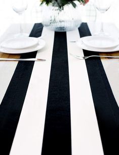 black and white striped table runner with flowers in vase