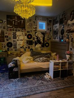 a bed room with a neatly made bed and lots of pictures on the wall