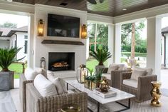 a living room filled with furniture and a flat screen tv mounted on the wall above a fireplace