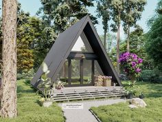 a - frame cabin in the middle of a grassy area with flowers and trees around it