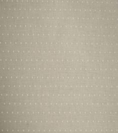 a beige background with white polka dots