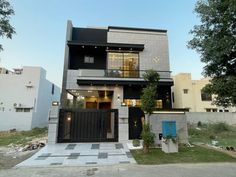 a modern house with black and white tiles on the front