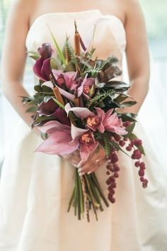 a bride holding a bouquet of flowers in her hands