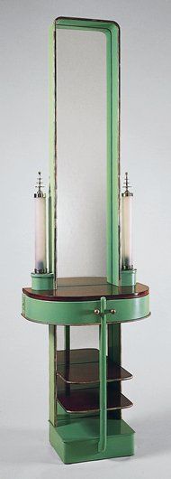 a green vanity with a mirror and two candles