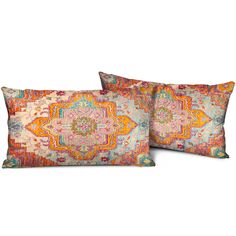 two decorative pillows with an orange, pink and blue pattern on the pillowcases