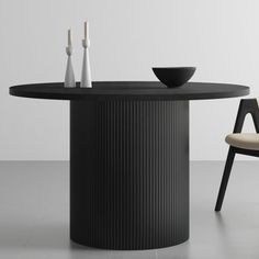 a black round table with two chairs around it