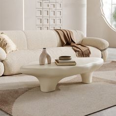 a living room with a white couch and coffee table