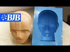 two plastic head molds sitting next to each other