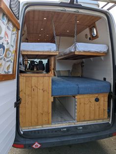 the back end of a van with two beds in it