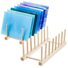 a set of four wooden easels with blue and purple folders on each side