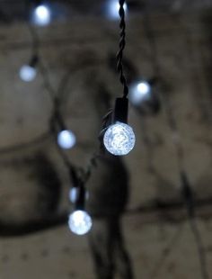 string lights hanging from the ceiling in a dark room