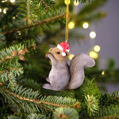 a squirrel ornament hanging from a christmas tree