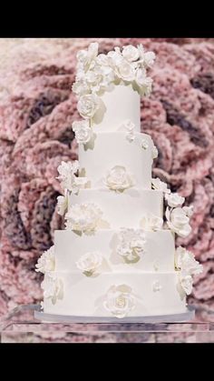 a wedding cake with white flowers on it