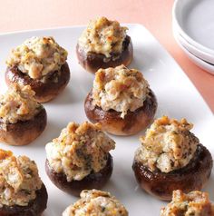 small stuffed mushrooms are on a white plate