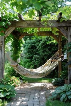 a hammock hanging in the middle of a garden