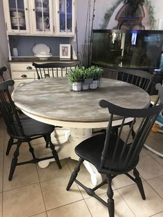 a kitchen table with four chairs around it