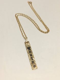 "6mm gold filled Hawaiian pendant with cable chain. The pendant is custom made with a name of your choice. The letters are engraved and enameled. Up to 7 letters can be engraved on the pendant with 1.5\" long . Up to 11 letters can be engraved on the pendant with 1.75\" long. The letters engraved are old english style, typical of Hawaiian heirloom jewelry. The pendant comes with a gold filled cable chain with the length of your choice. All the characters are engraved , not stamped, resulting in Gold Personalized Spiritual Charm Necklaces, Personalized 14k Gold Spiritual Charm Necklaces, Personalized 14k Gold Spiritual Charm Necklace, Spiritual 14k Gold Personalized Charm Necklaces, Gold Engraved Name Necklace Rectangular, Gold Engraved Rectangular Name Necklace, Gold Stamped Pendant Charm Necklace, Gold Hand Stamped Necklace With Rectangular Pendant, Gold Necklace With Hand Stamped Rectangular Pendant