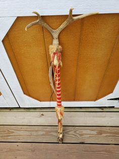 a deer's antler hanging from the side of a door